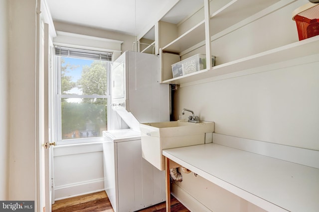 815 Aspen St NW, Washington, DC 20012 - washroom featuring estacked washer and dryer and wood finished floors