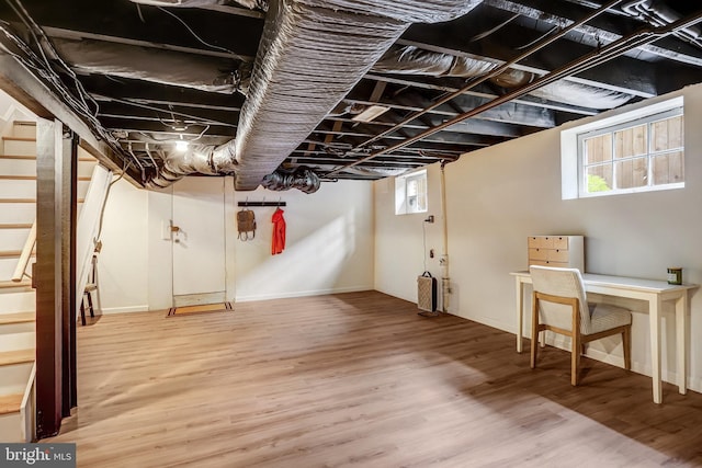 815 Aspen St NW, Washington, DC 20012 - below grade area with wood finished floors, healthy amount of natural light, and stairway
