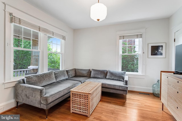815 Aspen St NW, Washington, DC 20012 - living area featuring healthy amount of natural light, light wood-style floors, and baseboards