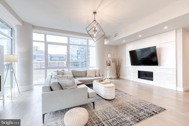 1330 Lancaster St Unit C701, Baltimore, MD 21231 - living room featuring baseboards, light wood finished floors, a glass covered fireplace, and recessed lighting