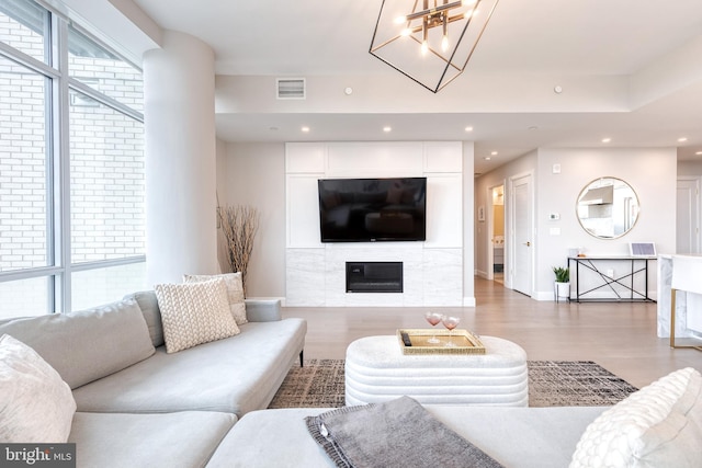 1330 Lancaster St Unit C701, Baltimore, MD 21231 - living area with wood finished floors, recessed lighting, a glass covered fireplace, a chandelier, and baseboards