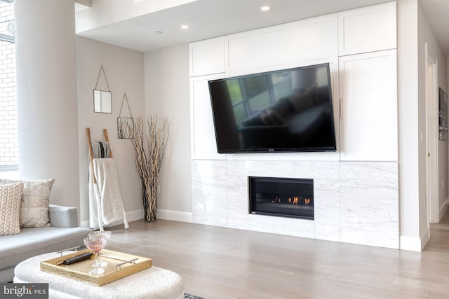 1330 Lancaster St Unit C701, Baltimore, MD 21231 - living room featuring wood finished floors, a tile fireplace, baseboards, and recessed lighting