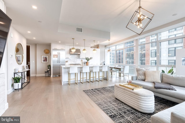 1330 Lancaster St Unit C701, Baltimore, MD 21231 - living room with a chandelier, baseboards, light wood finished floors, and recessed lighting