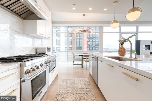 1330 Lancaster St Unit C701, Baltimore, MD 21231 - kitchen with appliances with stainless steel finishes, a sink, wall chimney range hood, recessed lighting, and white cabinetry