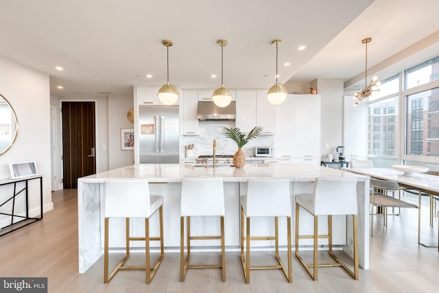1330 Lancaster St Unit C701, Baltimore, MD 21231 - kitchen with stainless steel built in refrigerator, under cabinet range hood, white cabinets, recessed lighting, and a large island