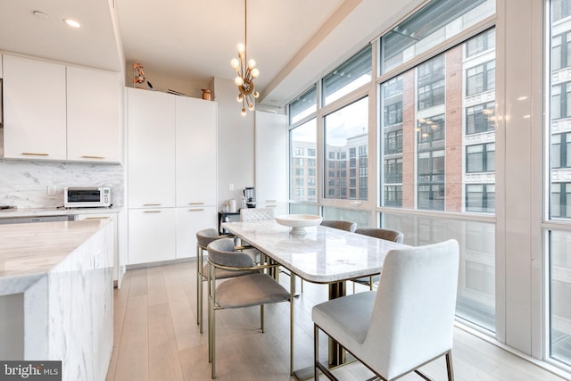 1330 Lancaster St Unit C701, Baltimore, MD 21231 - dining area featuring light wood-style floors and a chandelier