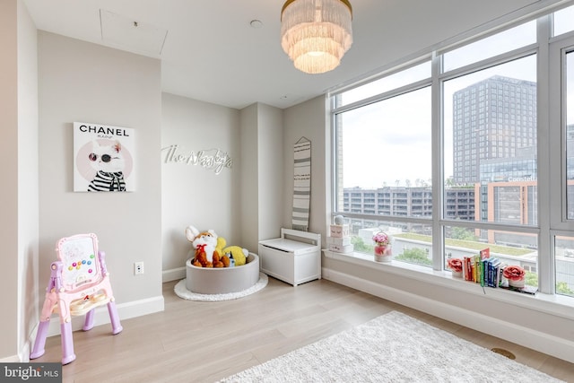 1330 Lancaster St Unit C701, Baltimore, MD 21231 - recreation room featuring plenty of natural light, wood finished floors, baseboards, and attic access