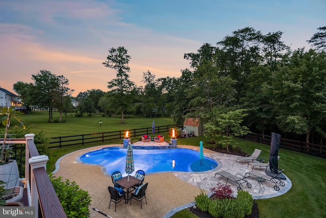 7633 Great Dover St, Gainesville, VA 20155 - pool at dusk with a fenced backyard, a patio, a storage unit, and view of wooded area