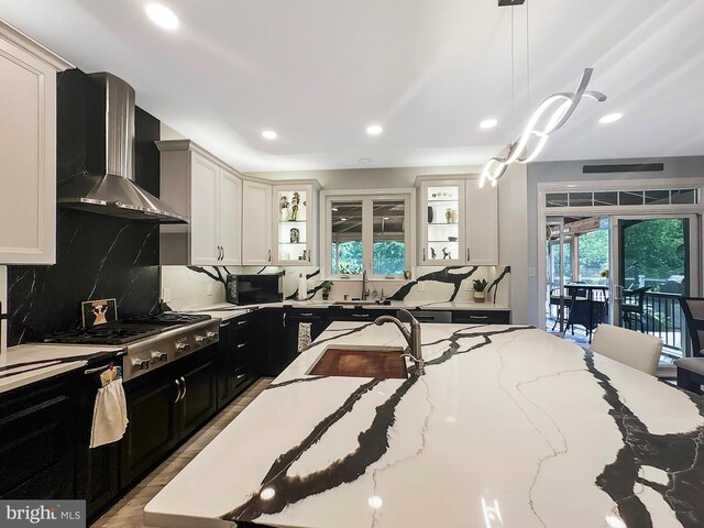 7633 Great Dover St, Gainesville, VA 20155 - kitchen with wall chimney range hood, dark cabinets, a sink, tasteful backsplash, and recessed lighting