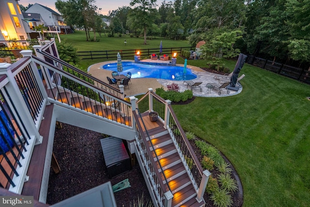 7633 Great Dover St, Gainesville, VA 20155 - pool at dusk featuring stairway, a patio area, a fenced backyard, and a deck
