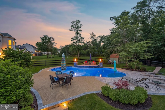 7633 Great Dover St, Gainesville, VA 20155 - pool at dusk with a patio, a fenced backyard, and a shed