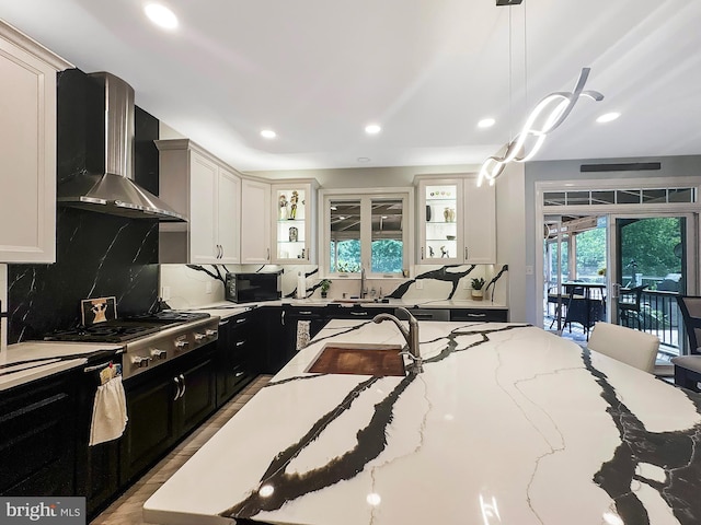 7633 Great Dover St, Gainesville, VA 20155 - kitchen with wall chimney exhaust hood, dark cabinets, stainless steel gas stovetop, tasteful backsplash, and recessed lighting