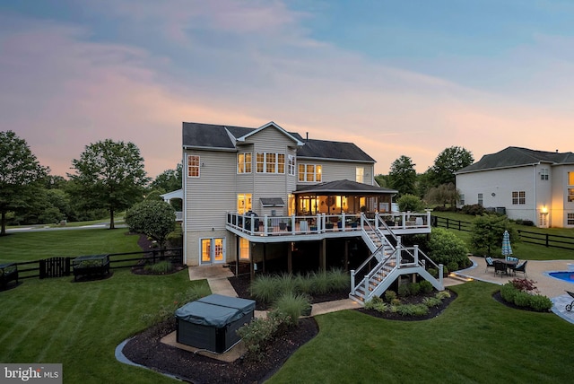 7633 Great Dover St, Gainesville, VA 20155 - back of property at dusk featuring a wooden deck, a gazebo, a patio, a fenced backyard, and stairs