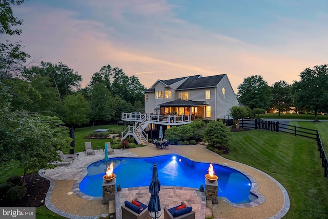 7633 Great Dover St, Gainesville, VA 20155 - pool at dusk with a wooden deck, stairs, a fenced backyard, and a patio