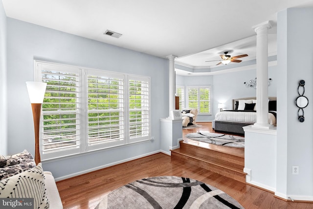 7633 Great Dover St, Gainesville, VA 20155 - bedroom with decorative columns, wood finished floors, and a raised ceiling