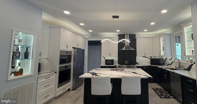 7633 Great Dover St, Gainesville, VA 20155 - kitchen featuring a sink, a center island with sink, recessed lighting, tasteful backsplash, and freestanding refrigerator