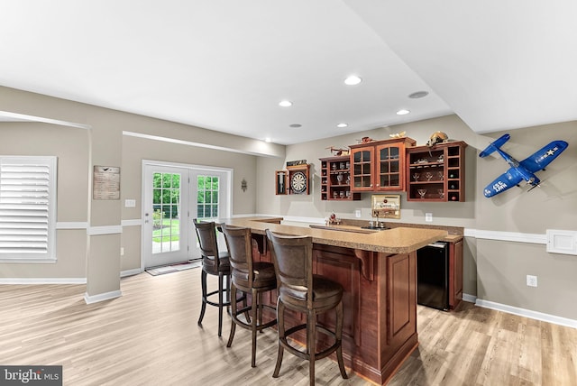 7633 Great Dover St, Gainesville, VA 20155 - indoor wet bar featuring light wood-style flooring, recessed lighting, and fridge