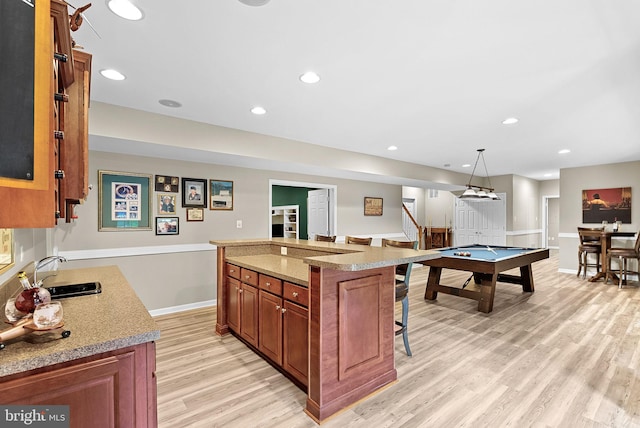 7633 Great Dover St, Gainesville, VA 20155 - kitchen with a breakfast bar area, light wood-type flooring, pool table, recessed lighting, and a center island