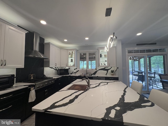 7633 Great Dover St, Gainesville, VA 20155 - kitchen featuring wall chimney range hood, recessed lighting, a sink, tasteful backsplash, and stainless steel gas stovetop