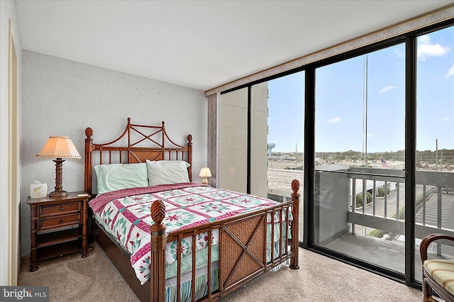 9900 Coastal Hwy Unit 401, Ocean City, MD 21842 - bedroom with carpet floors, access to exterior, and expansive windows