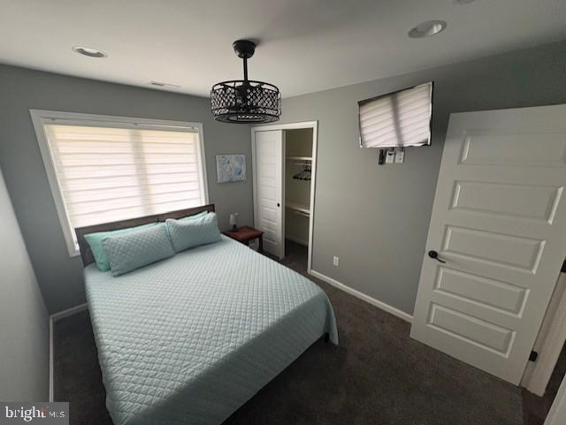 303 Ellendale Cir, Salisbury, MD 21804 - bedroom featuring dark colored carpet, a closet, and a chandelier