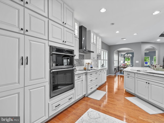 34897 Seagrass Plantation Ln, Dagsboro, DE 19939 - kitchen featuring arched walkways, double oven, a sink, white cabinetry, and recessed lighting