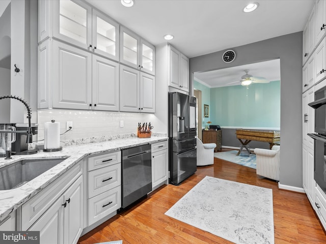 34897 Seagrass Plantation Ln, Dagsboro, DE 19939 - kitchen with refrigerator with ice dispenser, stainless steel dishwasher, a sink, ceiling fan, and white cabinets