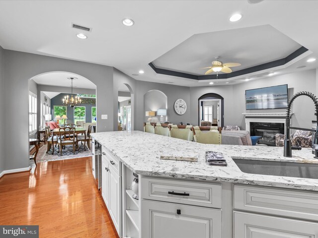 34897 Seagrass Plantation Ln, Dagsboro, DE 19939 - kitchen featuring arched walkways, a sink, ceiling fan, a chandelier, and recessed lighting
