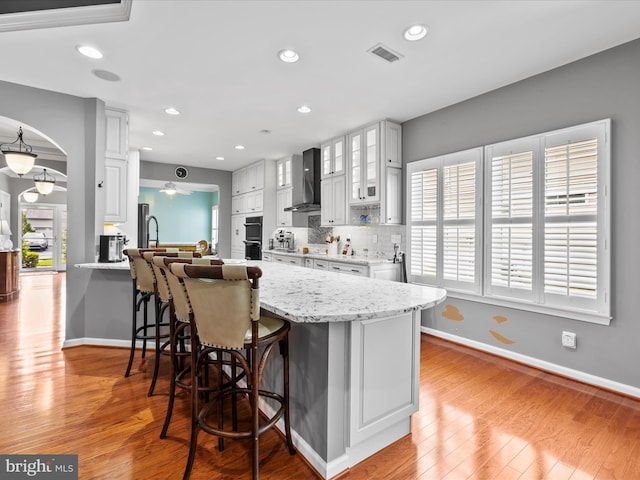 34897 Seagrass Plantation Ln, Dagsboro, DE 19939 - kitchen with a peninsula, a kitchen breakfast bar, baseboards, light wood finished floors, and recessed lighting