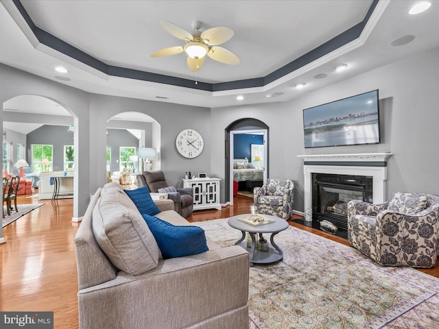 34897 Seagrass Plantation Ln, Dagsboro, DE 19939 - living room featuring a ceiling fan, a raised ceiling, recessed lighting, wood finished floors, and arched walkways