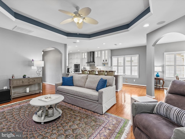34897 Seagrass Plantation Ln, Dagsboro, DE 19939 - living area featuring arched walkways, a ceiling fan, light wood-type flooring, recessed lighting, and baseboards