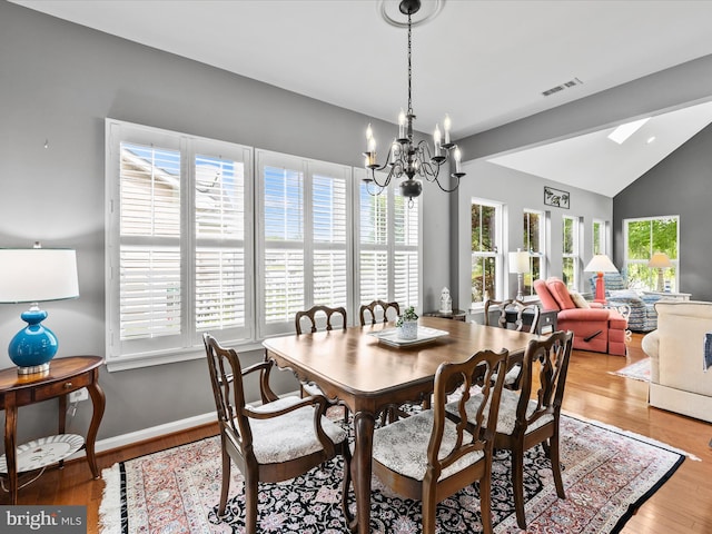 34897 Seagrass Plantation Ln, Dagsboro, DE 19939 - dining space featuring vaulted ceiling, a chandelier, light wood-type flooring, and baseboards