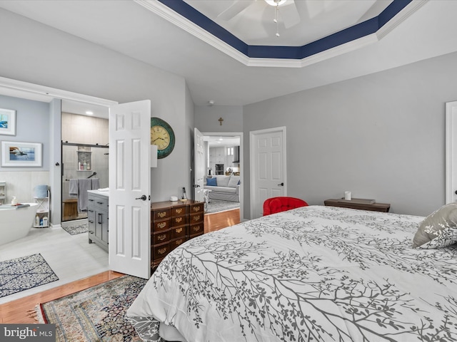 34897 Seagrass Plantation Ln, Dagsboro, DE 19939 - bedroom with a tray ceiling, wood finished floors, and a barn door