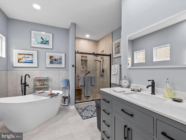 34897 Seagrass Plantation Ln, Dagsboro, DE 19939 - full bathroom featuring vanity, a shower stall, a soaking tub, tile walls, and recessed lighting