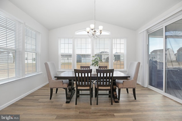 6293 Bobcat Ln, King George, VA 22485 - dining area featuring a chandelier, vaulted ceiling, wood finished floors, and baseboards