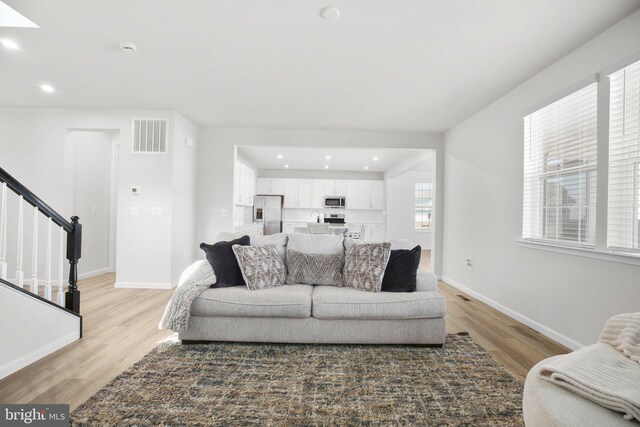 6293 Bobcat Ln, King George, VA 22485 - living room with light wood-style floors, stairway, baseboards, and recessed lighting