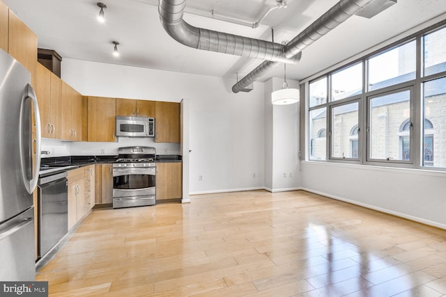 811 4th St NW Unit 320, Washington, DC 20001 - kitchen featuring stainless steel appliances, dark countertops, plenty of natural light, and baseboards