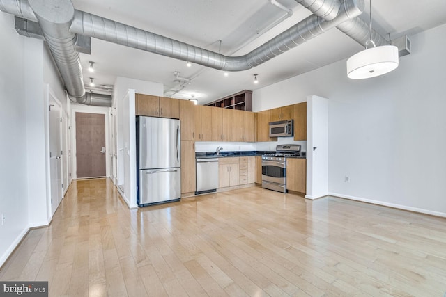 811 4th St NW Unit 320, Washington, DC 20001 - kitchen featuring stainless steel appliances, a sink, light wood-style flooring, dark countertops, and baseboards