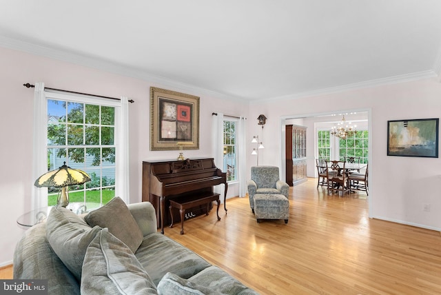 20783 Laplume Pl, Ashburn, VA 20147 - living area with a chandelier, plenty of natural light, ornamental molding, and light wood-style floors