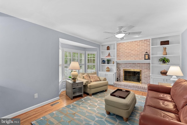 20783 Laplume Pl, Ashburn, VA 20147 - living room featuring a ceiling fan, wood finished floors, baseboards, crown molding, and built in shelves