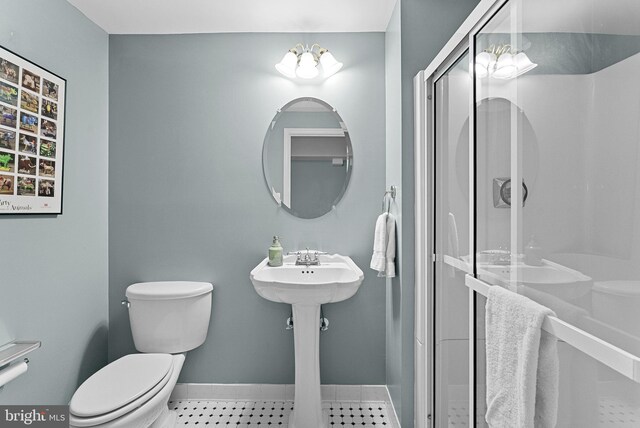 20783 Laplume Pl, Ashburn, VA 20147 - bathroom featuring toilet, baseboards, and a shower stall