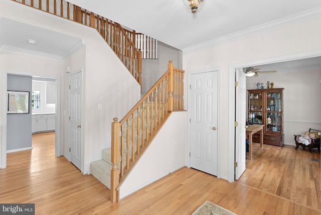 20783 Laplume Pl, Ashburn, VA 20147 - stairs featuring wood finished floors, crown molding, and baseboards
