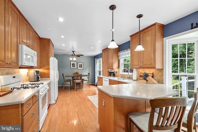 14428 William Carr Ln, Centreville, VA 20120 - kitchen with white appliances, a sink, a peninsula, recessed lighting, and light countertops
