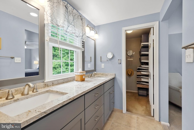 14428 William Carr Ln, Centreville, VA 20120 - full bath with double vanity, tile patterned flooring, a ceiling fan, baseboards, and a spacious closet