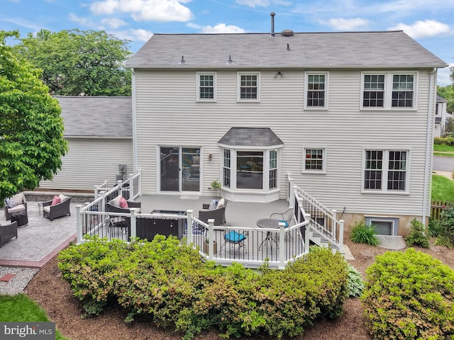 14428 William Carr Ln, Centreville, VA 20120 - back of house featuring a patio, a deck, an outdoor hangout area, and roof with shingles