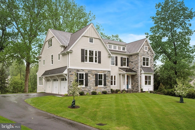 215 S Spring Mill Rd, Villanova, PA 19085 - shingle-style home with stone siding, driveway, a front yard, and a garage
