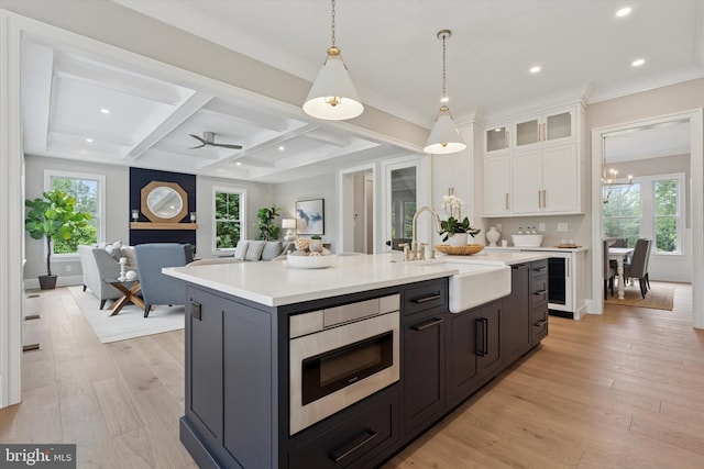215 S Spring Mill Rd, Villanova, PA 19085 - kitchen featuring a sink, stainless steel microwave, white cabinetry, light countertops, and coffered ceiling
