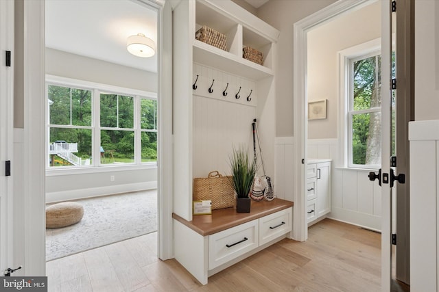 215 S Spring Mill Rd, Villanova, PA 19085 - mudroom featuring light wood finished floors, a wainscoted wall, and a decorative wall
