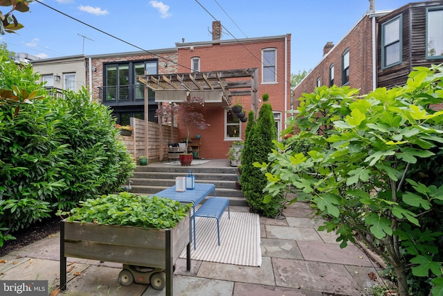 135 13th St NE, Washington, DC 20002 - rear view of house with brick siding, a pergola, and a chimney
