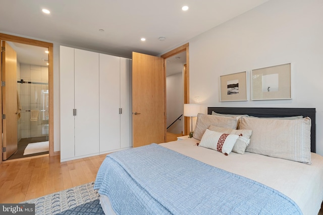 135 13th St NE, Washington, DC 20002 - bedroom with light wood-type flooring, recessed lighting, and ensuite bathroom